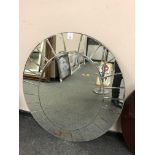 An oval all glass bevelled mirror