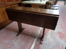 An early twentieth century mahogany ship's style drop leaf table with brass mounts