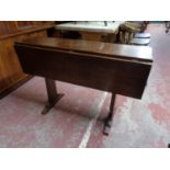 An early twentieth century mahogany ship's style drop leaf table with brass mounts