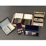 A tray of cased EPNS cutlery sets and a boxed set of six similar napkin rings