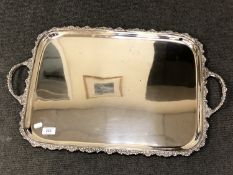 A large silver plated twin handled serving tray,