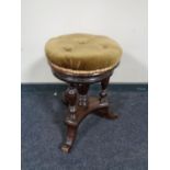 A Victorian revolving adjustable piano stool