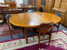 A circular teak mid century extending table and four chairs