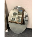 An all glass oval mirror