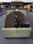 An early twentieth century tin trunk containing two heavy duty saw blades,