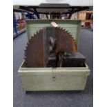 An early twentieth century tin trunk containing two heavy duty saw blades,