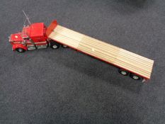 A remote controlled Kenworth Freight truck with flat bed trailer and two container boxes