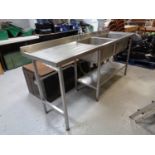 A stainless steel double sink unit with drainer