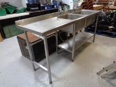 A stainless steel double sink unit with drainer