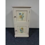 An antique painted pine double door cabinet