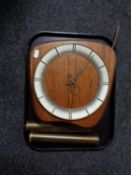 A mid century walnut wall clock with pendulum and weights