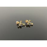 A pair of gold and diamond crucifix earrings