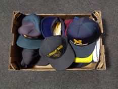 A box of peaked caps to include US marine Smit international USS Pamito,