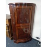 An early twentieth century mahogany double corner cabinet