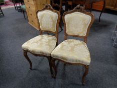 A pair of French walnut carved bedroom chairs in classical fabric