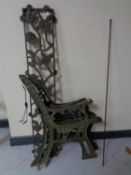 Two pairs of cast iron bench ends together with a cast iron bench back panel