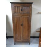 An Edwardian oak double door wardrobe