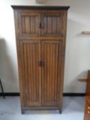 An Edwardian oak double door wardrobe