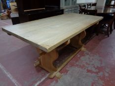 A blonde oak refectory dining table