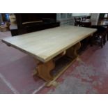A blonde oak refectory dining table