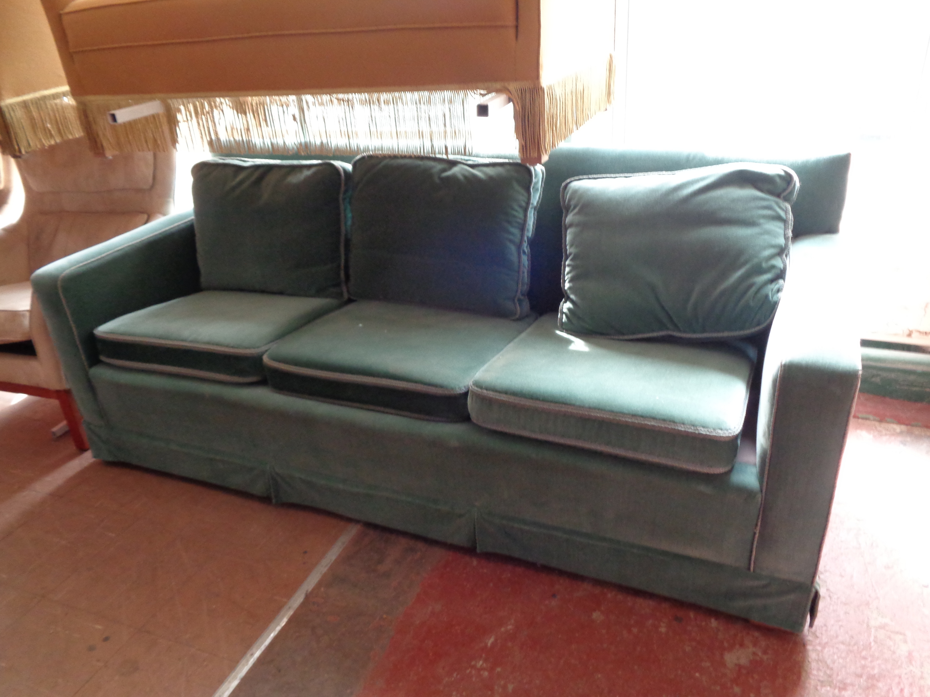 A mid century three seater settee in turquoise fabric