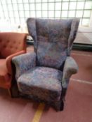 A twentieth century wing backed armchair in floral fabric