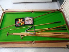 A 6' slate bed table topped snooker table with accessories, cues,