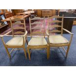 A set of six Ercol elm ladder backed dining chairs comprising of two carvers, four singles.