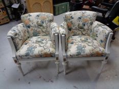 A set of four white painted armchairs in bird of paradise style fabric