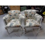 A set of four white painted armchairs in bird of paradise style fabric