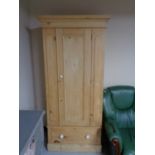 An antique pine single door wardrobe fitted a drawer