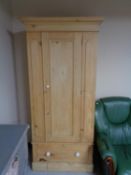 An antique pine single door wardrobe fitted a drawer