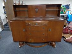 A mid century serpentine fronted oak buffet sideboard