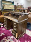 An Edwardian oak roll topped desk