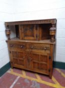 A carved oak buffet backed sideboard