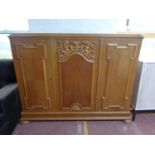 A twentieth century continental oak triple door sideboard on bun feet