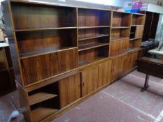 A mid century Danish bookcase fitted with sliding cupboards beneath