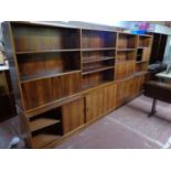 A mid century Danish bookcase fitted with sliding cupboards beneath