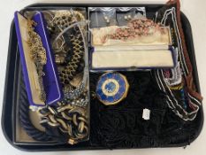 A tray of costume jewellery, ornate necklaces, earrings, cameo brooch, beaded scarf,
