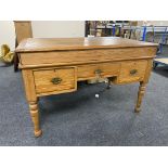 A pitch pine lift top writing desk fitted with three drawers