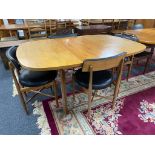 A mid century G-plan teak extending dining table together with a set of four G-plan teak chairs