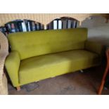 A mid century settee in light green fabric