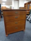 An early twentieth century mahogany and pine four drawer chest on bun feet