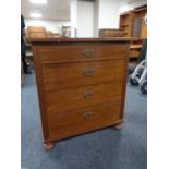 An early twentieth century mahogany and pine four drawer chest on bun feet