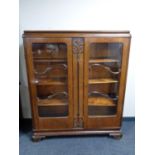 A twentieth century walnut double door display cabinet