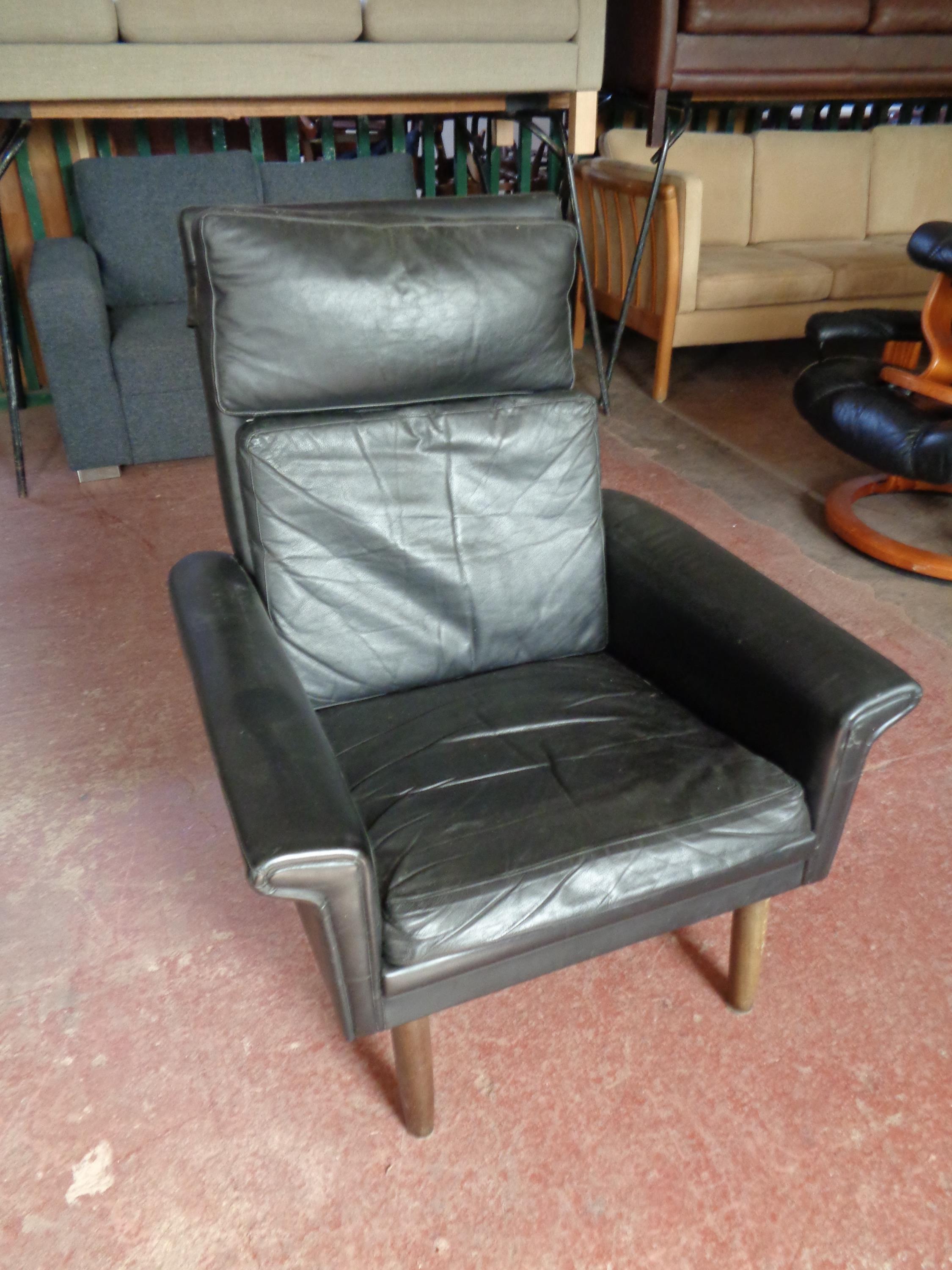 A mid century Danish black leather armchair