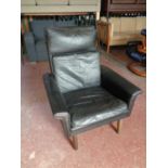 A mid century Danish black leather armchair