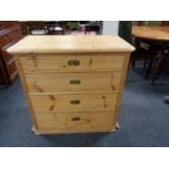 An antique pine four drawer chest