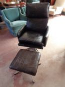 A mid century Danish black leather armchair with similar stool