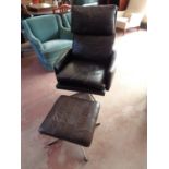 A mid century Danish black leather armchair with similar stool